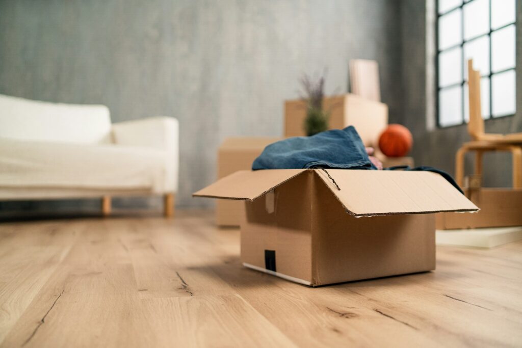 Empty living room with cardbord boxes already packed, moving home concept