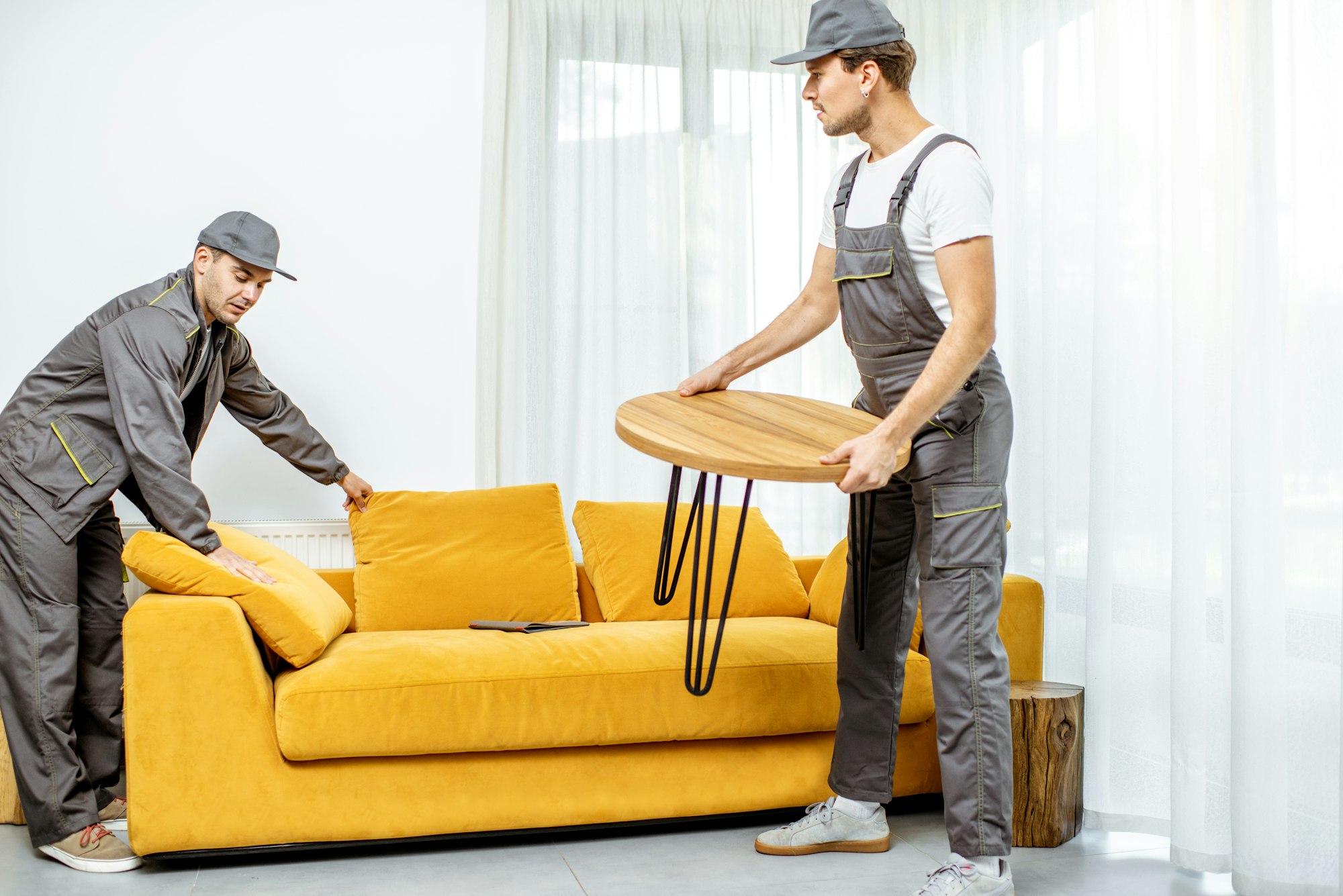 Movers placing furniture at home