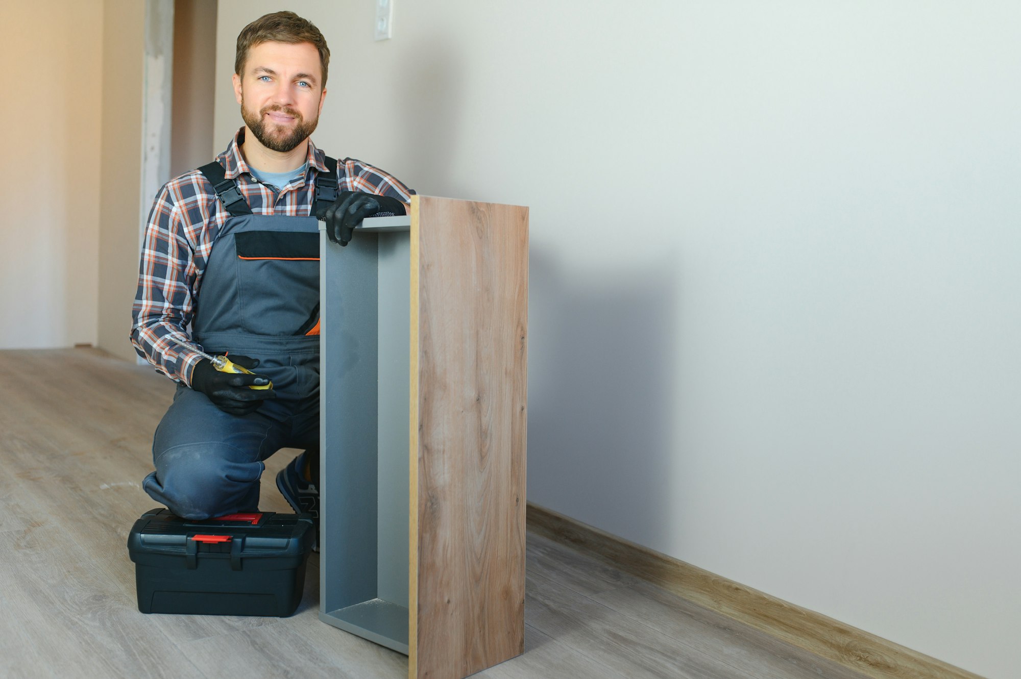 Professional Furniture Assembly Worker Assembles Shelf.